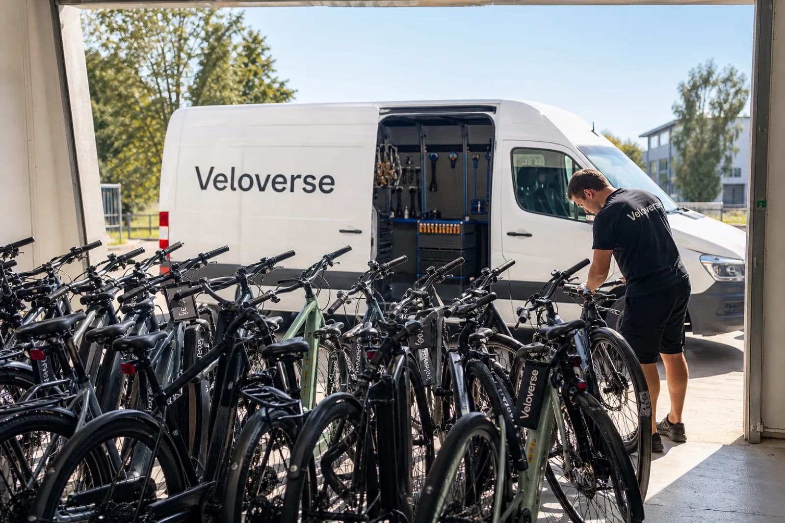VeloVerse staff loading bikes at the service van